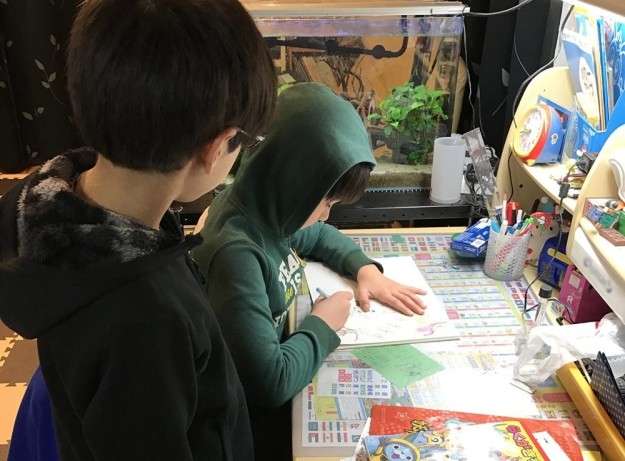 Thomas' sons working on a creature